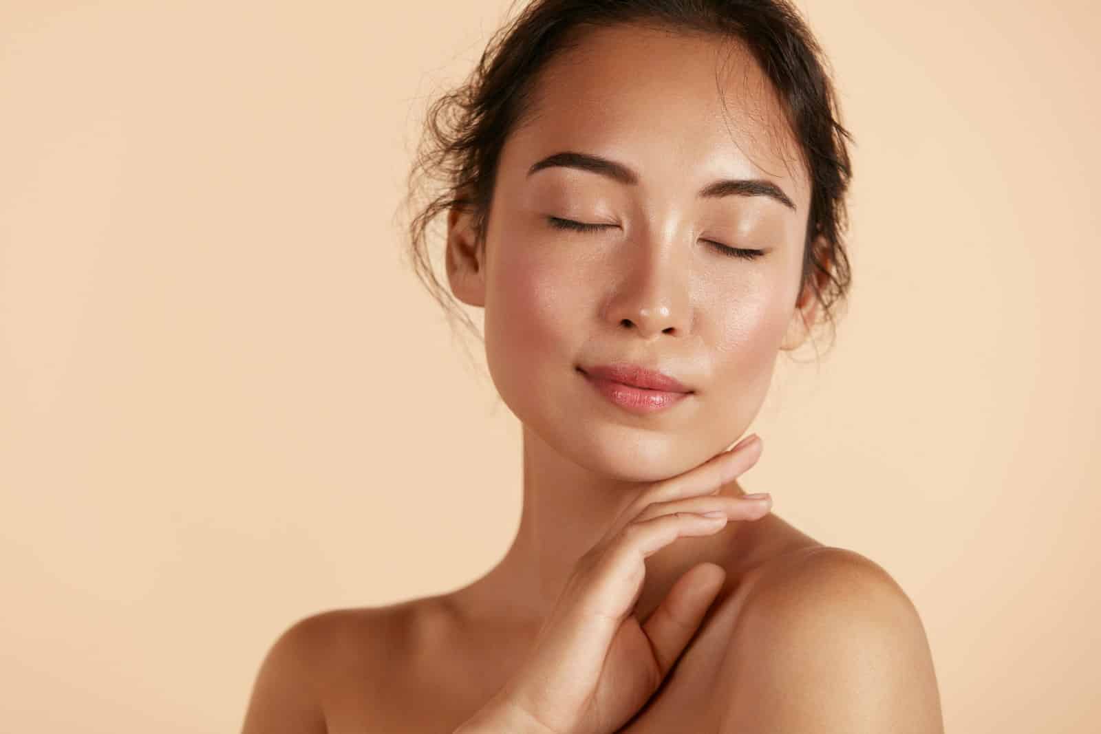 beautiful Asian woman face and hand skin care healthy skin