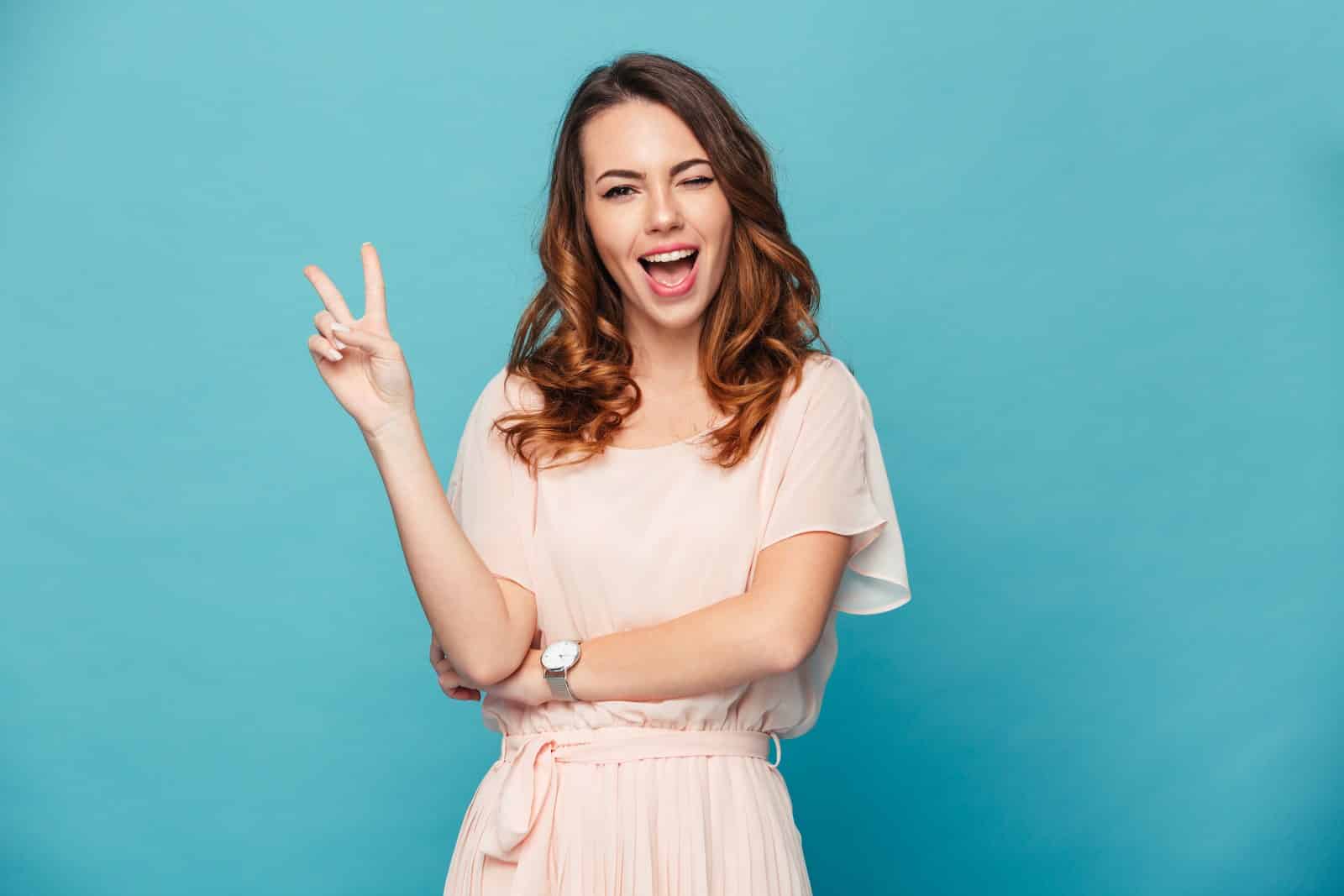 happy confident woman blue background white dress
