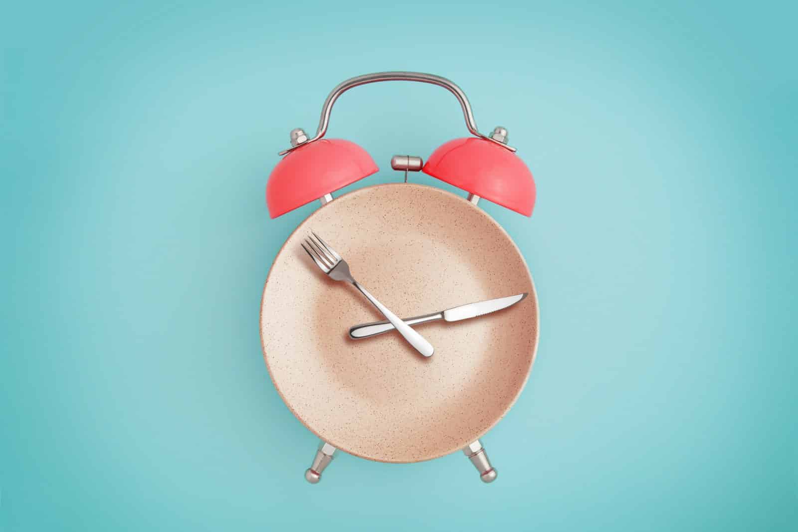health nutrition food alarm clock forks green background aging clock